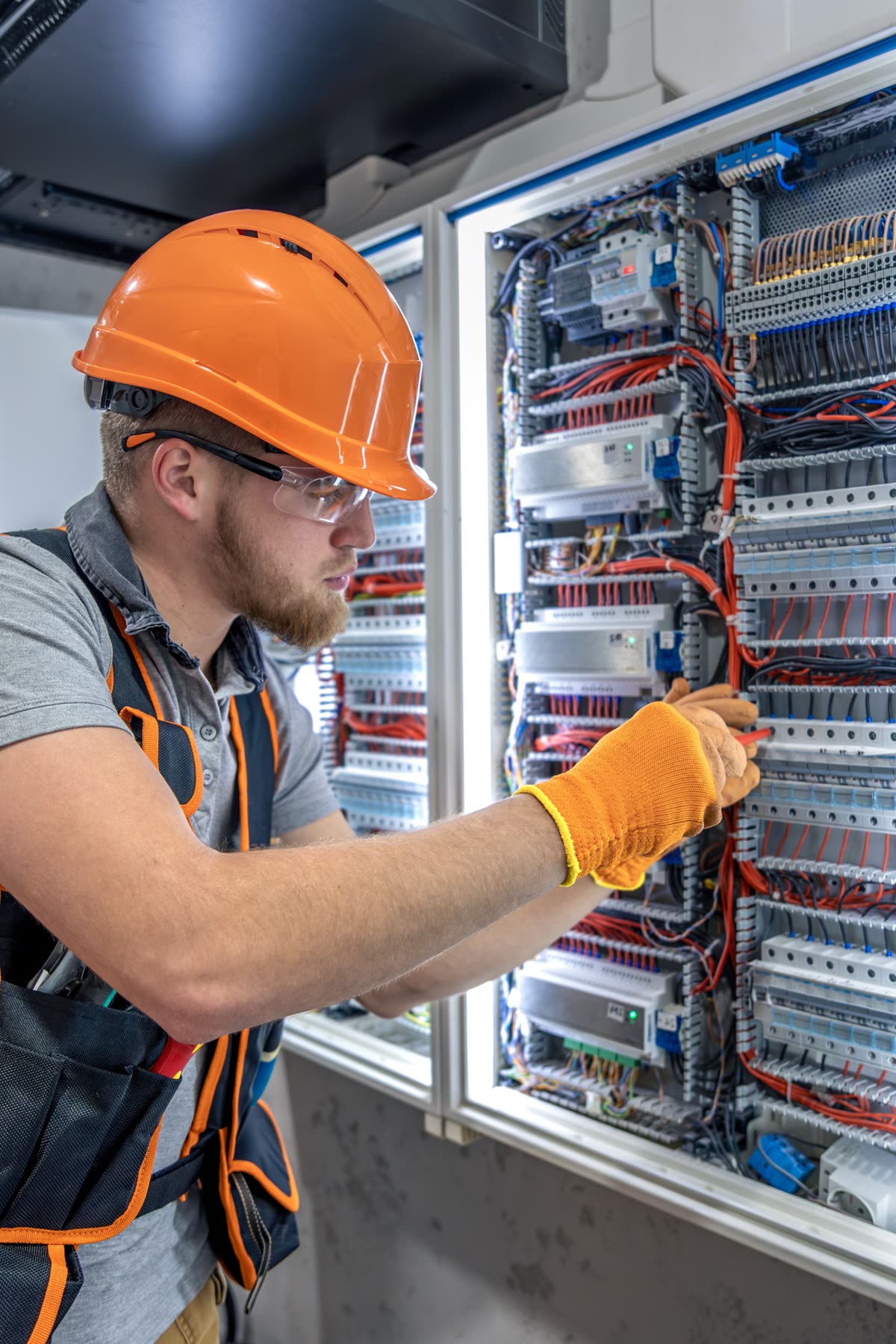 Accounting for electrical contractors — electrician wiring a distribution board