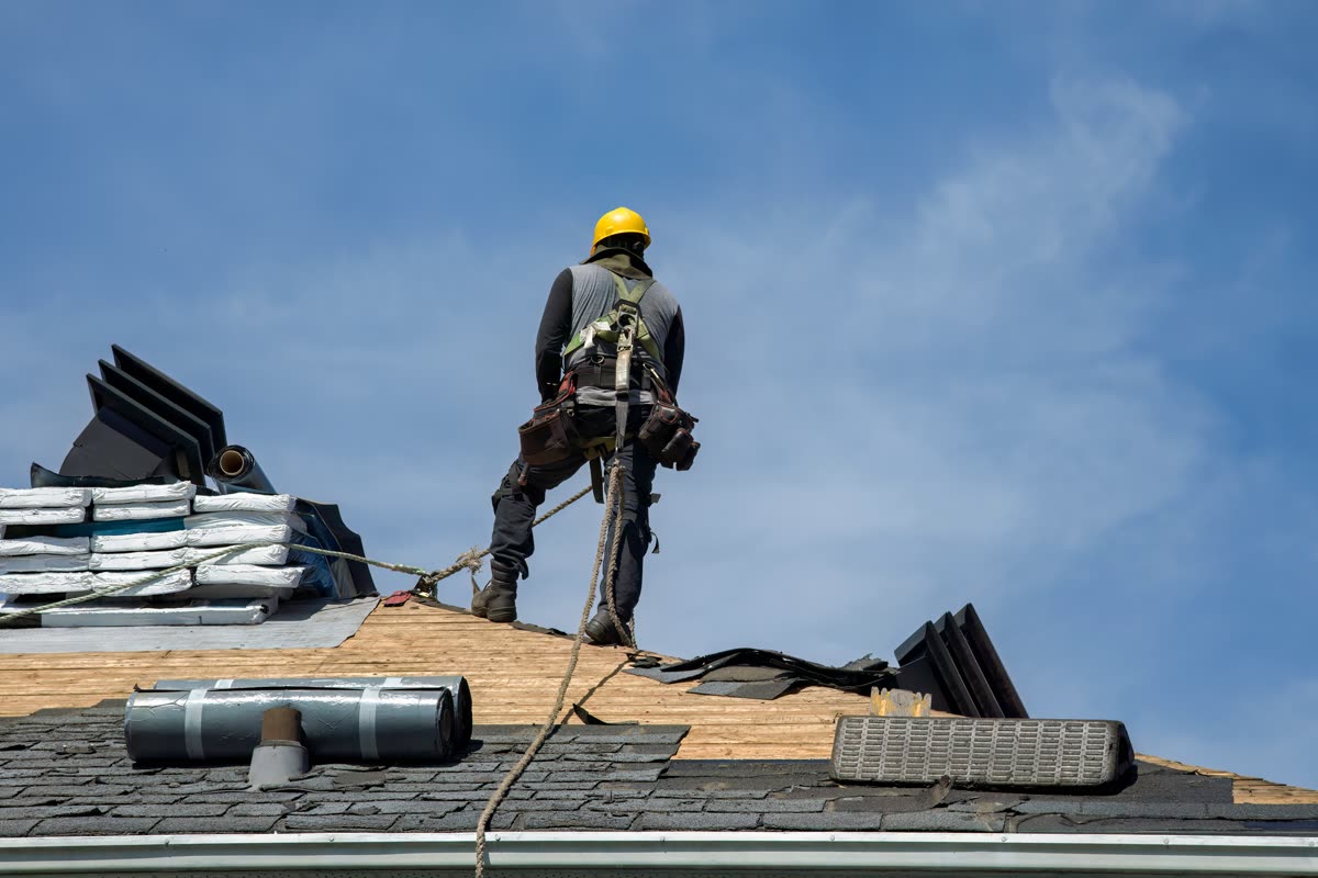 Accounting for roofers — roofer working on a shingle roof